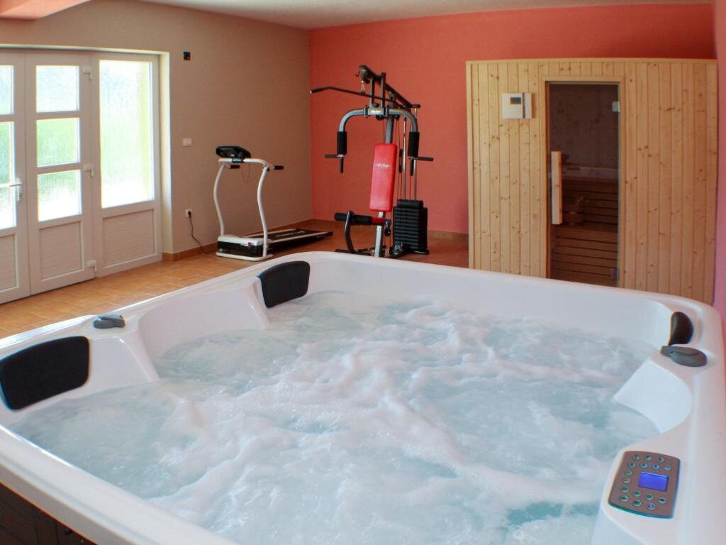 Hidromasažna kada, finska sauna i sprave za vježbanje u wellness prostoriji Ville Kikize